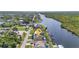 Waterfront home boasts private dock access, and is surrounded by lush greenery at 18566 Arapahoe Cir, Port Charlotte, FL 33948