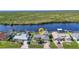 Waterfront home with private dock surrounded by lush foliage in a serene setting at 18566 Arapahoe Cir, Port Charlotte, FL 33948