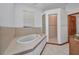 Bathroom featuring a soaking tub and walk-in shower at 18566 Arapahoe Cir, Port Charlotte, FL 33948