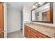 Elegant bathroom with a granite countertop, glass vessel sink, storage, and a mirrored wall cabinet at 18566 Arapahoe Cir, Port Charlotte, FL 33948