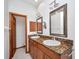 A bathroom with double sinks and wood cabinets at 18566 Arapahoe Cir, Port Charlotte, FL 33948