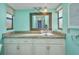 Modern bathroom with granite countertops, a clear glass vessel sink, and a large, decorative framed mirror at 18566 Arapahoe Cir, Port Charlotte, FL 33948