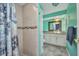 Stylish bathroom featuring a clear glass vessel sink, a decorative framed mirror and a tiled shower at 18566 Arapahoe Cir, Port Charlotte, FL 33948