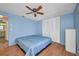 A bedroom with light blue walls and a ceiling fan at 18566 Arapahoe Cir, Port Charlotte, FL 33948