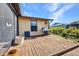 Outdoor deck with a stainless steel grill, mature landscaping and blue skies at 18566 Arapahoe Cir, Port Charlotte, FL 33948