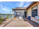 Large backyard wooden deck overlooking pool, waterfront, and covered patio seating at 18566 Arapahoe Cir, Port Charlotte, FL 33948