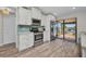 White kitchen with stainless steel appliances and access to the outdoor patio area at 18566 Arapahoe Cir, Port Charlotte, FL 33948
