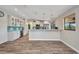 Modern kitchen with white cabinets, stainless steel appliances, and bar seating at 18566 Arapahoe Cir, Port Charlotte, FL 33948