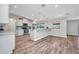 Well-lit kitchen with white cabinetry, stainless steel appliances, and a breakfast bar at 18566 Arapahoe Cir, Port Charlotte, FL 33948