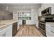 Open kitchen with white cabinets, stainless appliances, and granite countertops at 18566 Arapahoe Cir, Port Charlotte, FL 33948