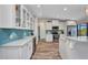 Bright kitchen featuring white cabinetry, stainless steel appliances, and a blue tile backsplash at 18566 Arapahoe Cir, Port Charlotte, FL 33948