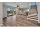 Bright living room with wood floors, a staircase, and a view of the pool at 18566 Arapahoe Cir, Port Charlotte, FL 33948