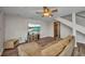 Cozy living room featuring wood-look flooring, comfortable seating, and a ceiling fan at 18566 Arapahoe Cir, Port Charlotte, FL 33948