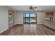 Spacious living room featuring wood floors and access to a screened-in pool area at 18566 Arapahoe Cir, Port Charlotte, FL 33948
