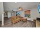 Spacious living room with a sectional sofa, wood-look floors, and natural light from the windows at 18566 Arapahoe Cir, Port Charlotte, FL 33948