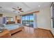 Bright bedroom featuring a ceiling fan, wood floors and access to private patio at 18566 Arapahoe Cir, Port Charlotte, FL 33948