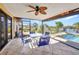 Covered patio features an outdoor dining area, overlooks a pool, and has a beautiful waterfront view at 18566 Arapahoe Cir, Port Charlotte, FL 33948