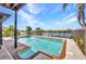 Outdoor pool with water view and a partially covered lanai on a sunny day at 18566 Arapahoe Cir, Port Charlotte, FL 33948
