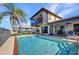 Backyard pool area with a large in-ground pool, a covered patio and beautiful views at 18566 Arapahoe Cir, Port Charlotte, FL 33948