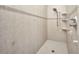 Updated tiled walk-in shower with a shower head and shower accessories at 18566 Arapahoe Cir, Port Charlotte, FL 33948