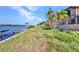 Waterfront backyard with dock, boat lift, and lush tropical landscaping at 18566 Arapahoe Cir, Port Charlotte, FL 33948