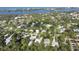 Overhead view of neighborhood lush trees, waterways, and houses at 2131 Heasley Rd, Englewood, FL 34223