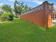 The property features a spacious backyard with well-maintained grass, bounded by a sturdy orange wall at 2131 Heasley Rd, Englewood, FL 34223