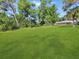 View of expansive backyard showcasing lush greenery and landscaping at 2131 Heasley Rd, Englewood, FL 34223
