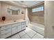 Well-lit bathroom with shower and tub combination and modern vanity at 2131 Heasley Rd, Englewood, FL 34223