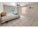 Bright bedroom featuring tile flooring and natural light through windows at 2131 Heasley Rd, Englewood, FL 34223