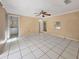A large bedroom has tile flooring and access to another room with a full bathroom at 2131 Heasley Rd, Englewood, FL 34223