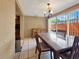 Traditional dining room features a decorative light fixture and neutral toned textured walls and tile floors at 2131 Heasley Rd, Englewood, FL 34223