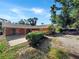 The house features a stucco exterior, a covered patio with arches, and a gravel driveway at 2131 Heasley Rd, Englewood, FL 34223