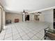 A large open living space with tile flooring, ceiling fans, and access to other rooms at 2131 Heasley Rd, Englewood, FL 34223