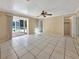A neutral living space with tile flooring, sliding glass door to the patio, and lots of natural light at 2131 Heasley Rd, Englewood, FL 34223