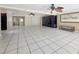 A very large open living space featuring tile floors, multiple ceiling fans, and a built-in entertainment unit at 2131 Heasley Rd, Englewood, FL 34223