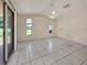 An open living space with tile flooring, sliding glass door, a ceiling fan and lots of natural light at 2131 Heasley Rd, Englewood, FL 34223
