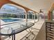 A covered patio looks out to a screened-in pool area, enhancing outdoor living and enjoyment at 2131 Heasley Rd, Englewood, FL 34223