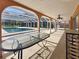 Inviting outdoor patio with screened pool, ceiling fan, table, and serving area perfect for entertaining guests at 2131 Heasley Rd, Englewood, FL 34223