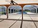 Covered outdoor patio provides shade and views of the screened-in private pool and surrounding greenery at 2131 Heasley Rd, Englewood, FL 34223