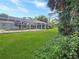 A screen enclosed pool area featuring well-maintained landscaping at 2131 Heasley Rd, Englewood, FL 34223