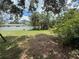 This grassy backyard is surrounded by lush greenery, offering a private and peaceful outdoor space at 2174 Schwalbe Way, Sarasota, FL 34235
