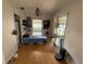 Bedroom with bright wood flooring, sliding glass door and decorated with personal items at 2174 Schwalbe Way, Sarasota, FL 34235