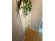 Narrow hallway with light wood flooring and a safety gate at the stairwell at 2174 Schwalbe Way, Sarasota, FL 34235