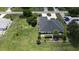 Aerial view of a home with lush landscaping, a white picket fence, and a well-maintained yard at 2244 Mauritania Rd, Punta Gorda, FL 33983