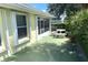 Covered backyard patio with a white table and chairs at 2244 Mauritania Rd, Punta Gorda, FL 33983