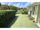 Covered patio area with green painted flooring and landscaped yard at 2244 Mauritania Rd, Punta Gorda, FL 33983