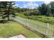 Green backyard with white picket fence at 2244 Mauritania Rd, Punta Gorda, FL 33983