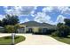 Inviting one-story home with a circle drive, freshly painted exterior, and mature landscaping at 2244 Mauritania Rd, Punta Gorda, FL 33983