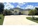 Charming home with mature landscaping, a spacious driveway, and an attached garage at 2244 Mauritania Rd, Punta Gorda, FL 33983